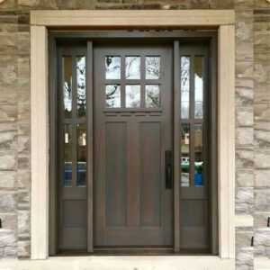 The picture shows a stone home with a beautiful entry door with side lights excellent work done by an entry door installer.